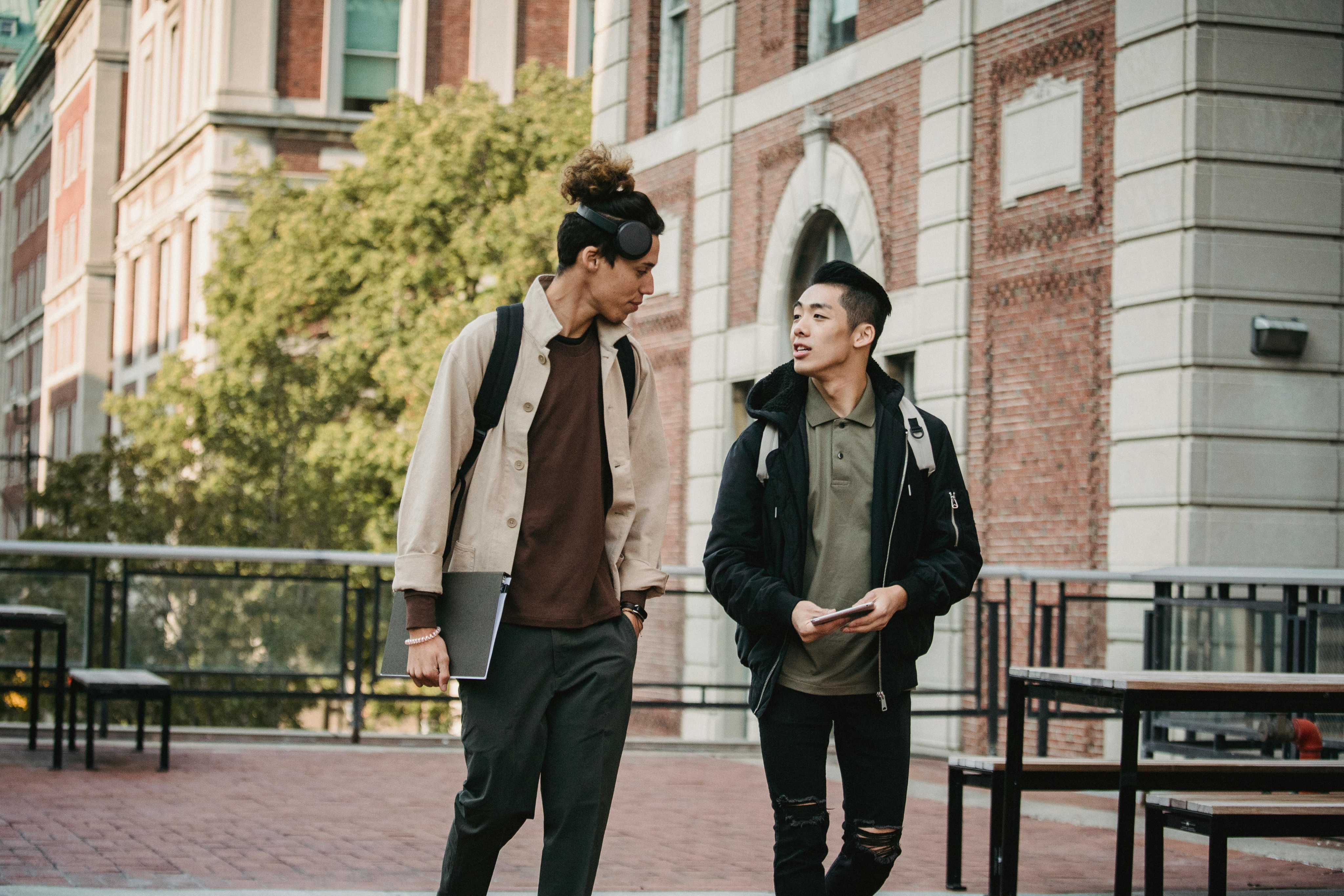 Friends walking and talking on campus